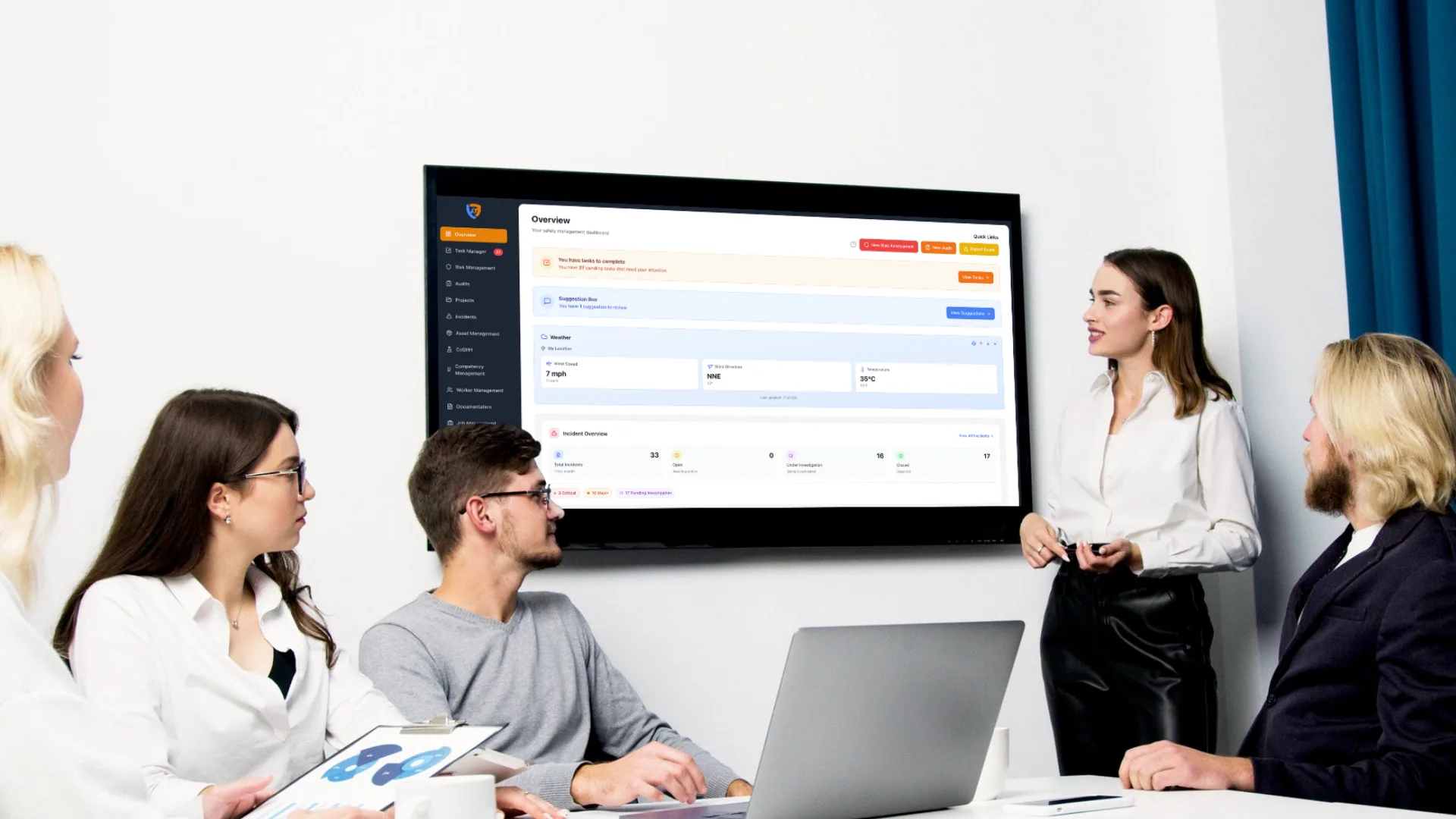 Team reviewing the live Safety Mate® overview dashboard on a meeting room screen